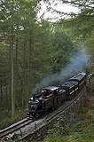 ‘Merddin Emrys’ runs round Whistling Curve with an up train formed of the Spooner era set.       (16/10/2005)