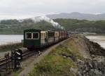 The vintage train heads out across the Cob as the rain clouds gather   (04/05/2003)