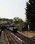 After a little helping hand, gravity takes over again and the slate train rolls out onto the main line at Minffordd.   (01/05/2004)