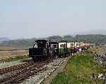 Looking like a summer's day, Linda returns to Harbour Station with a down train.   (01/05/2004)