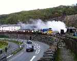 ‘Taliesin’ disappears in a cloud of steam as ‘Vale of Ffestiniog’ & ‘Criccieth Castle’ head round Boston Lodge curve.   (02/05/2004)