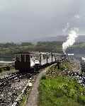 The Earl's train glints in the morning sunlight as it runs out along the Cob.   (03/05/2004)