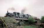 ‘Blanche’ leads ‘Mountaineer’ over the original route at Rhoslyn Bridge, Dduallt, and off along the Deviation   (04/05/1997)