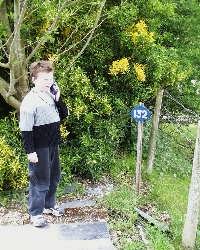 James learns about Spooner's Minffordd Exchange Sidings as he listens to story number 132 at the end of Minffordd platform.   (03/05/2004)