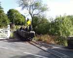 A gravity slate train rolls across Penrhyn level crossing   (12/10/2002)