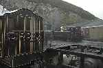 Boston Lodge yard was host to ‘Taliesin’ in steam as spare engine, the curly roofed van spent the day in front of the erecting shop.   (25/09/2004)