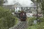 The ‘Flying Flea’ has grown by a further two carriages as it negotiates Penrhyn crossing.   (25/09/2004)