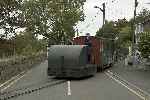 The Simplex crosses the road at Penrhyn with it’s single carriage train to Tan-y-Bwlch - 1:38pm.   (26/09/2004)