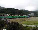 ‘Thomas Bach’ has just crossed the new river bridge and heads for Llanberis on the new section of line.   (06/08/2003)