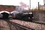 Pacific No 7 ‘Typhoon’ emerges from the bridge at the west end of New Romney station to pass through non-stop for Hythe with the ‘Golden Jubilee’ named service   (07/08/1982)