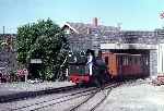 ‘Talyllyn’ emerges from under the road bridge into Tywyn Wharf station   (02/08/1981)