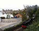 Off again, 143 departs from Caernarfon, the castle in the distance   (27/09/2003)