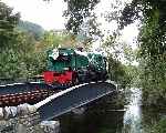 Garratt 138 ‘Millennium’ crosses the Afon Gwyrfai at Plas-y-nant with a late afternoon train   (27/09/2003)