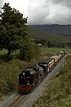 143 runs downhill towards Castell Cidwm with a down mixed train.       (17/09/2005)