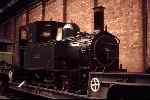  in lined green livery sits on a standard gauge well wagon in the Peter Allan Building, National Railway Museum   (27/09/1985)