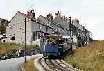 Car No 5 heads round the corner and up the hill away from the lower section passing point}, the brakesman stands on the lower balcony.   (27/07/1981)